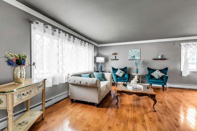 117 E Madison St, East Islip, NY 11730 - living area featuring baseboard heating, hardwood / wood-style flooring, and ornamental molding