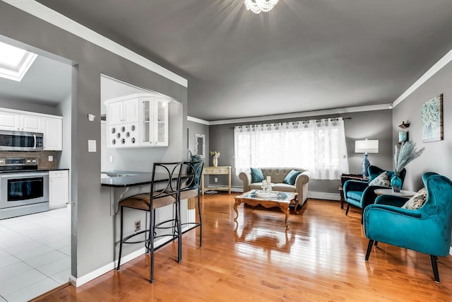 117 E Madison St, East Islip, NY 11730 - living room with crown molding, light wood-style flooring, and a skylight