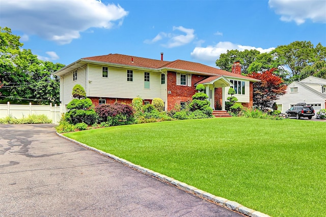 18 Pashen Pl, Dix Hills, NY 11746 - bi-level home with brick siding, a chimney, and driveway
