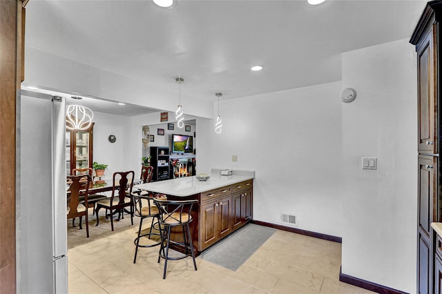 18 Pashen Pl, Dix Hills, NY 11746 - kitchen featuring freestanding refrigerator, a peninsula, light countertops, recessed lighting, and hanging light fixtures