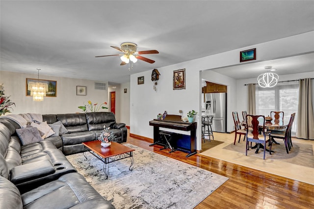18 Pashen Pl, Dix Hills, NY 11746 - living room with a chandelier, light wood-type flooring, and a ceiling fan
