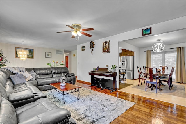 18 Pashen Pl, Dix Hills, NY 11746 - living area featuring a chandelier, light wood finished floors, and ceiling fan
