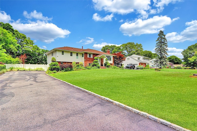 18 Pashen Pl, Dix Hills, NY 11746 - bi-level home with driveway, brick siding, and a chimney