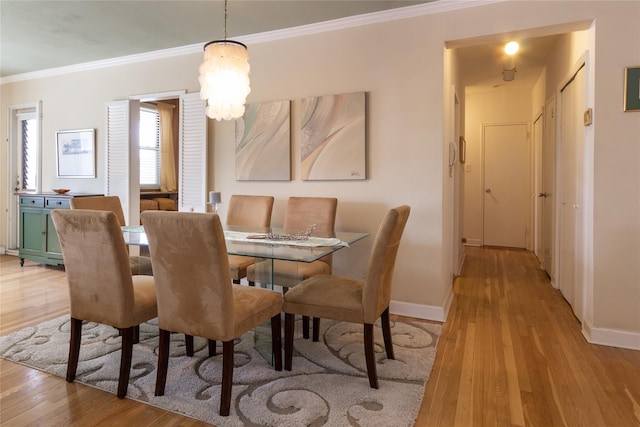 162-41 Powells Cove Blvd Unit 4K, Beechhurst, NY 11357 - dining room with crown molding, light wood-style flooring, and a chandelier