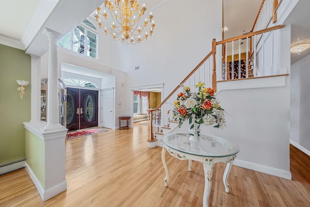 3 Kohlsaat Ct, Smithtown, NY 11787 - entryway featuring stairway, a high ceiling, wood finished floors, decorative columns, and crown molding