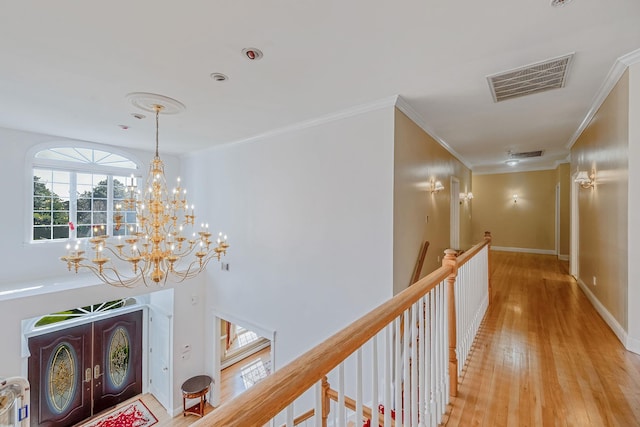 3 Kohlsaat Ct, Smithtown, NY 11787 - corridor with an upstairs landing, light wood-type flooring, a chandelier, and ornamental molding