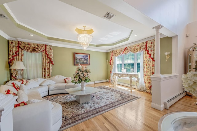 3 Kohlsaat Ct, Smithtown, NY 11787 - living room featuring a tray ceiling, baseboard heating, ornamental molding, decorative columns, and light wood-style floors