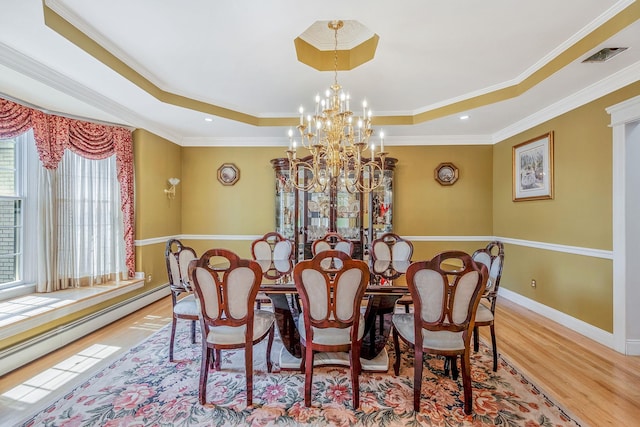 3 Kohlsaat Ct, Smithtown, NY 11787 - dining space with a tray ceiling, wood finished floors, a baseboard heating unit, a chandelier, and crown molding