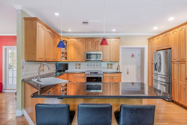 3 Kohlsaat Ct, Smithtown, NY 11787 - kitchen with appliances with stainless steel finishes, a kitchen breakfast bar, tasteful backsplash, light wood-style floors, and ornamental molding