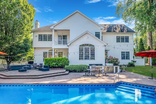 3 Kohlsaat Ct, Smithtown, NY 11787 - back of house featuring a balcony, an outdoor pool, a chimney, and a patio area