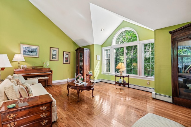 10 Bryan Meadow Path, Northport, NY 11768 - living area featuring healthy amount of natural light, wood finished floors, lofted ceiling, and a baseboard heating unit
