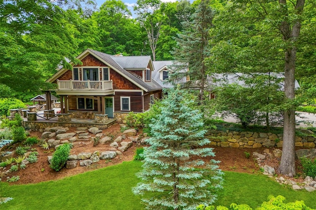 17 Half Moon Rdg, Cold Spring, NY 10516 - view of front of property featuring a porch, stone siding, a balcony, and a front yard
