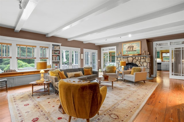 17 Half Moon Rdg, Cold Spring, NY 10516 - living room with beam ceiling, light wood-style flooring, french doors, and a stone fireplace