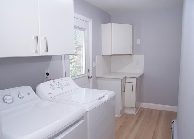 121 Lower Sheep Pasture Rd, East Setauket, NY 11733 - laundry room featuring washer and dryer, cabinet space, and light wood-style flooring
