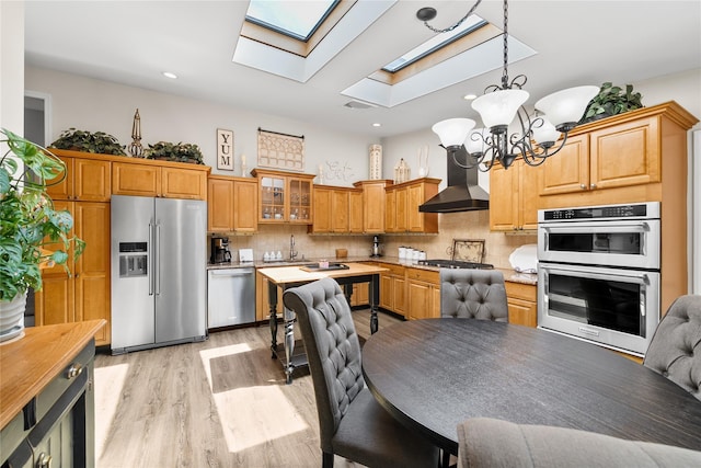 506 Kime Ave, West Islip, NY 11795 - kitchen with stainless steel appliances, wall chimney exhaust hood, a chandelier, a skylight, and light wood-type flooring