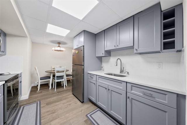 506 Kime Ave, West Islip, NY 11795 - kitchen featuring stainless steel appliances, gray cabinets, decorative backsplash, light countertops, and a paneled ceiling