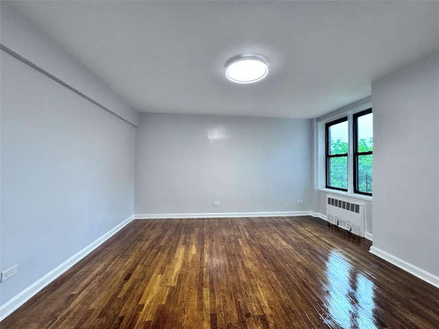 33-24 Junction Blvd Unit 6R, Jackson Heights, NY 11372 - empty room with radiator and dark wood-type flooring