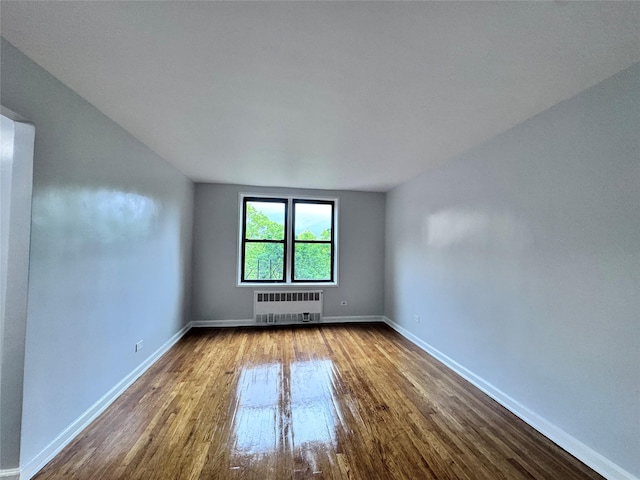 33-24 Junction Blvd Unit 6R, Jackson Heights, NY 11372 - unfurnished room featuring radiator heating unit and dark wood-style floors