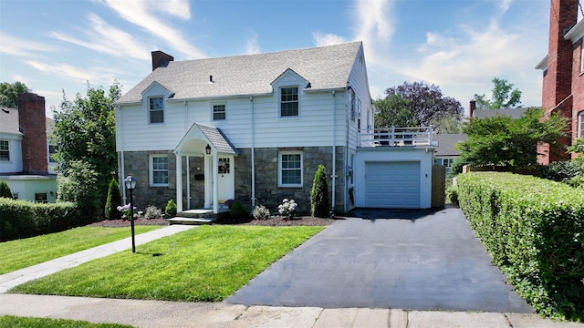 32 Biltmore Ave, Yonkers, NY 10710 - view of front of home featuring stone siding, asphalt driveway, a front lawn, and a balcony