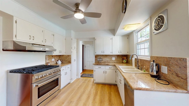 32 Biltmore Ave, Yonkers, NY 10710 - kitchen with high end range, under cabinet range hood, white cabinetry, light wood finished floors, and ceiling fan