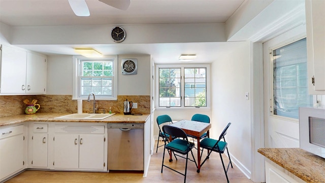 32 Biltmore Ave, Yonkers, NY 10710 - kitchen featuring stainless steel dishwasher, light wood-type flooring, decorative backsplash, and white cabinets