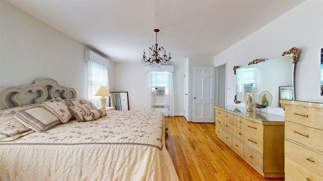 32 Biltmore Ave, Yonkers, NY 10710 - bedroom with a chandelier, radiator, light wood-style floors, and cooling unit