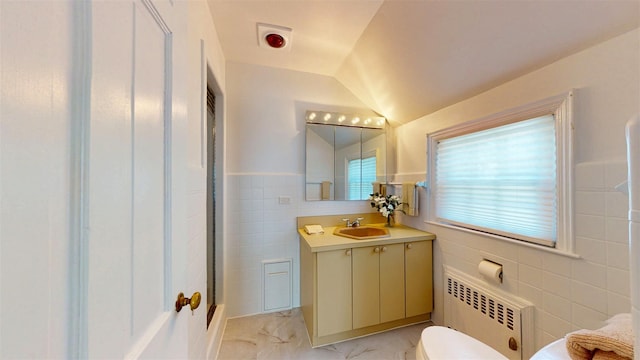 32 Biltmore Ave, Yonkers, NY 10710 - full bath featuring radiator, tile walls, vanity, marble look tile flooring, and lofted ceiling