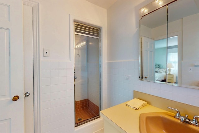 32 Biltmore Ave, Yonkers, NY 10710 - ensuite bathroom featuring tile walls, a shower stall, vanity, and wainscoting