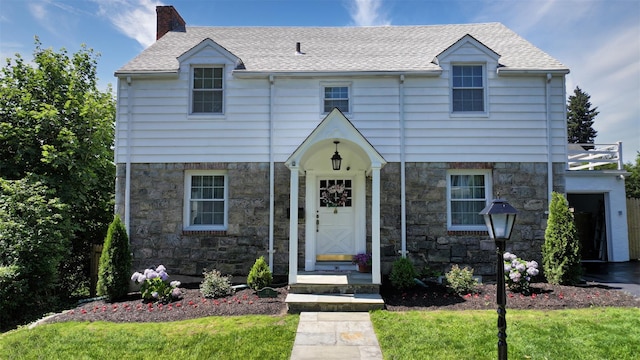32 Biltmore Ave, Yonkers, NY 10710 - view of front of home with stone siding, a chimney, and roof with shingles