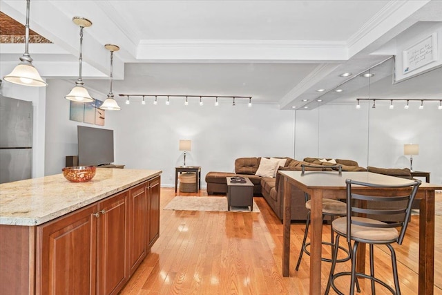 81 Edwards St Unit T, Roslyn Heights, NY 11577 - kitchen with light wood-type flooring, brown cabinets, open floor plan, pendant lighting, and light stone counters