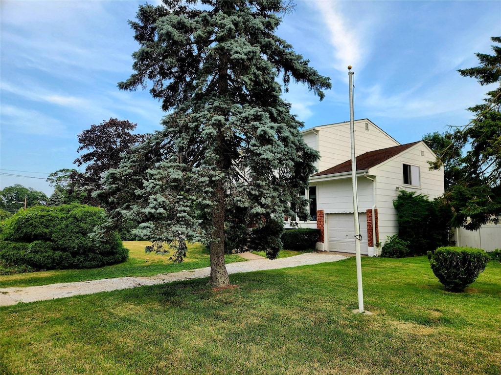 14 Brian Dr, East Islip, NY 11730 - view of home's exterior featuring a yard, driveway, and an attached garage