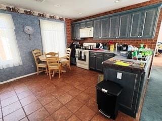 353 Litchfield Ave, Babylon, NY 11702 - kitchen with white appliances, dark tile patterned flooring, wallpapered walls, and light countertops