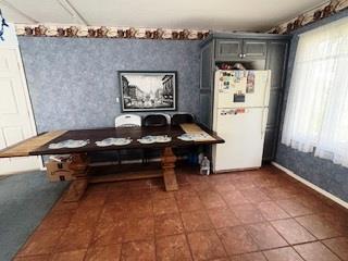353 Litchfield Ave, Babylon, NY 11702 - tiled dining room featuring baseboards