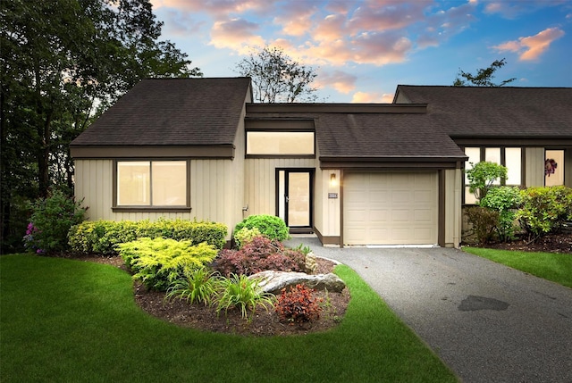 582 Heritage Hls Unit A, Somers, NY 10589 - mid-century home featuring an attached garage, asphalt driveway, a shingled roof, and a lawn