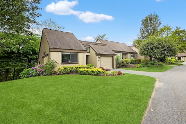 582 Heritage Hls Unit A, Somers, NY 10589 - view of front of home with a garage, concrete driveway, a front yard, and a shingled roof
