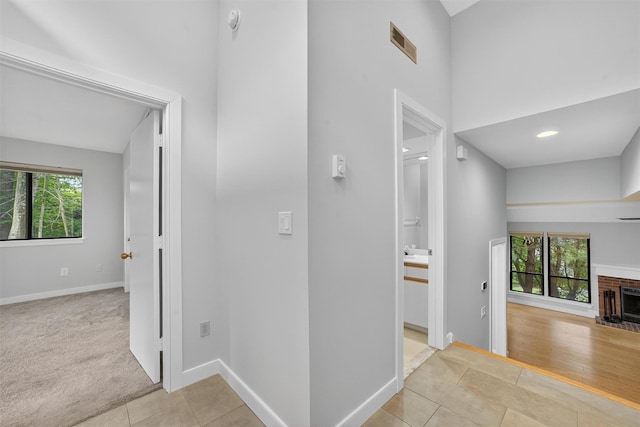 582 Heritage Hls Unit A, Somers, NY 10589 - hall featuring tile patterned flooring and a towering ceiling