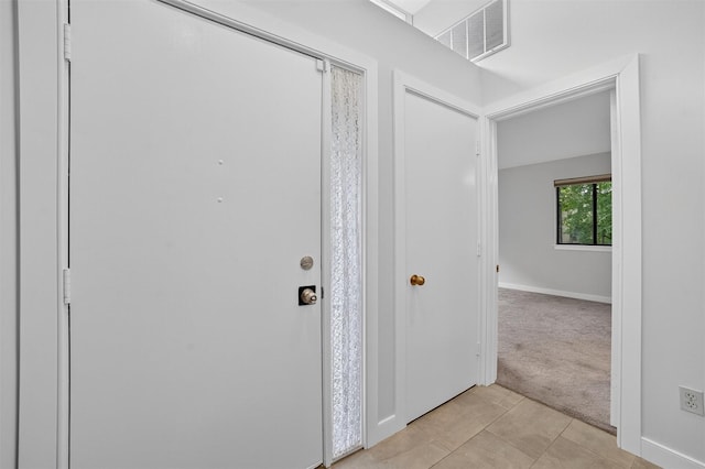 582 Heritage Hls Unit A, Somers, NY 10589 - foyer entrance featuring light tile patterned floors and light carpet