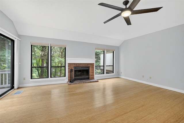 582 Heritage Hls Unit A, Somers, NY 10589 - unfurnished living room featuring vaulted ceiling, healthy amount of natural light, wood finished floors, ceiling fan, and a fireplace