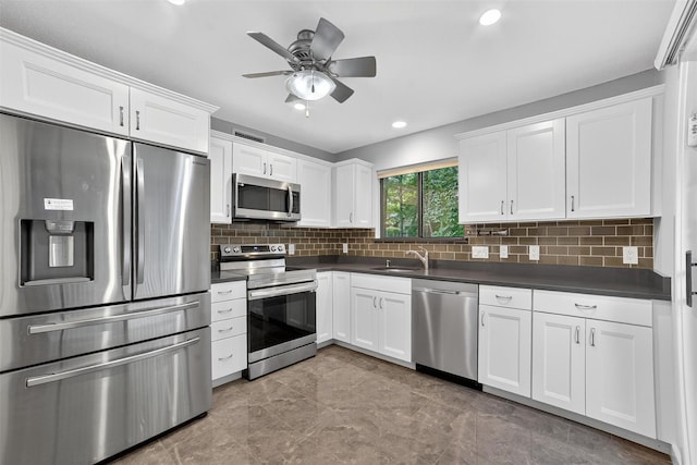 582 Heritage Hls Unit A, Somers, NY 10589 - kitchen with appliances with stainless steel finishes, dark countertops, white cabinets, tasteful backsplash, and recessed lighting