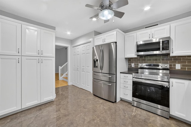 582 Heritage Hls Unit A, Somers, NY 10589 - kitchen with stainless steel appliances, dark countertops, white cabinetry, ceiling fan, and recessed lighting