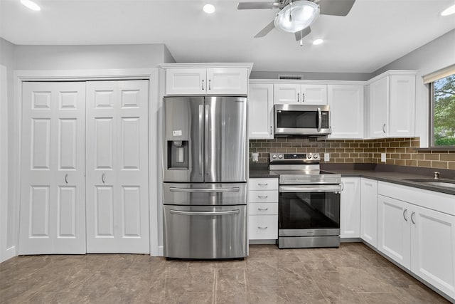 582 Heritage Hls Unit A, Somers, NY 10589 - kitchen featuring appliances with stainless steel finishes, dark countertops, white cabinets, a ceiling fan, and recessed lighting