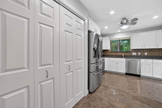 582 Heritage Hls Unit A, Somers, NY 10589 - kitchen with stainless steel appliances, dark countertops, backsplash, white cabinets, and recessed lighting