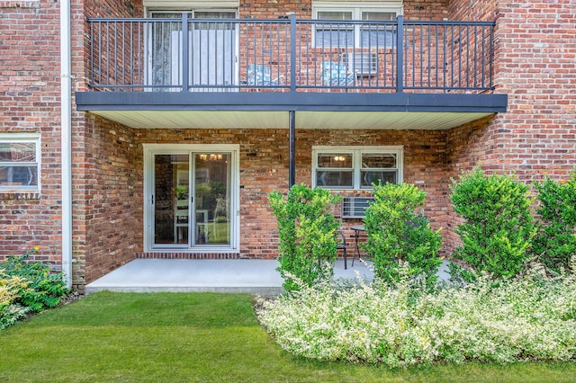 18 Ivy St Unit 4A, Farmingdale, NY 11735 - doorway to property with a balcony, brick siding, and a patio