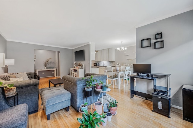 18 Ivy St Unit 4A, Farmingdale, NY 11735 - living area with a chandelier, ornamental molding, and light wood-style floors