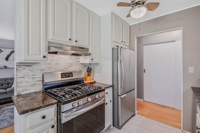 18 Ivy St Unit 4A, Farmingdale, NY 11735 - kitchen featuring appliances with stainless steel finishes, under cabinet range hood, a ceiling fan, decorative backsplash, and dark stone counters