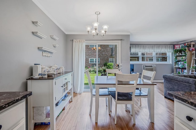 18 Ivy St Unit 4A, Farmingdale, NY 11735 - dining area with a chandelier, crown molding, light wood-type flooring, and baseboard heating