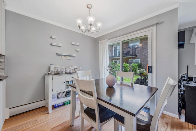 18 Ivy St Unit 4A, Farmingdale, NY 11735 - dining area with a baseboard heating unit, a chandelier, light wood-type flooring, and ornamental molding