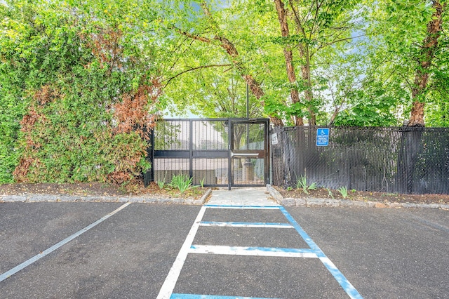 18 Ivy St Unit 4A, Farmingdale, NY 11735 - uncovered parking lot featuring a gate