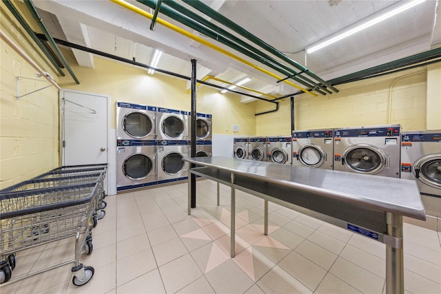 6 Birchwood Ct Unit 4C, Mineola, NY 11501 - community laundry room with stacked washer / drying machine, separate washer and dryer, concrete block wall, and a garage