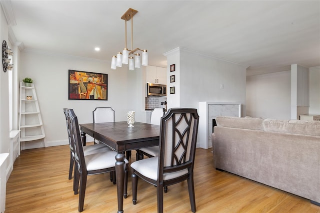 6 Birchwood Ct Unit 4C, Mineola, NY 11501 - dining space with light wood-style flooring, ornamental molding, and recessed lighting